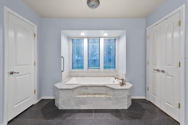 bathroom featuring a relaxing tiled tub