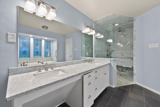 bathroom with tile patterned flooring, vanity, and tiled shower