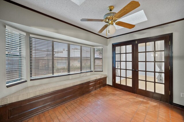 interior space with french doors and ceiling fan