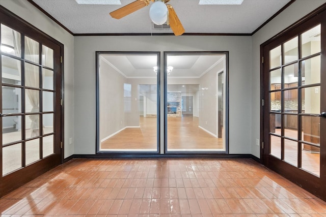 unfurnished sunroom featuring french doors and ceiling fan with notable chandelier