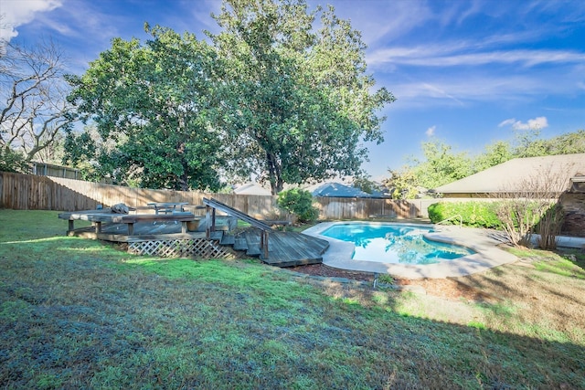 view of pool with a yard and a deck