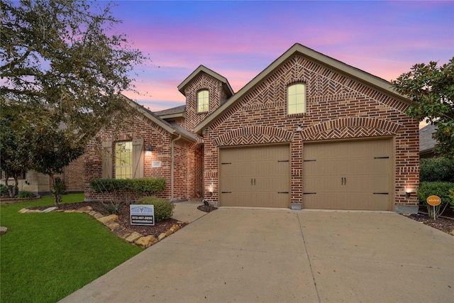 view of front of home with a garage, a front lawn, concrete driveway, and brick siding