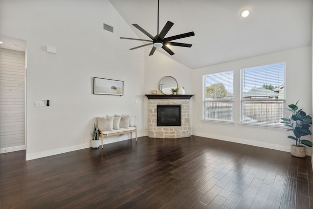 unfurnished living room featuring a stone fireplace, ceiling fan, high vaulted ceiling, and dark hardwood / wood-style floors