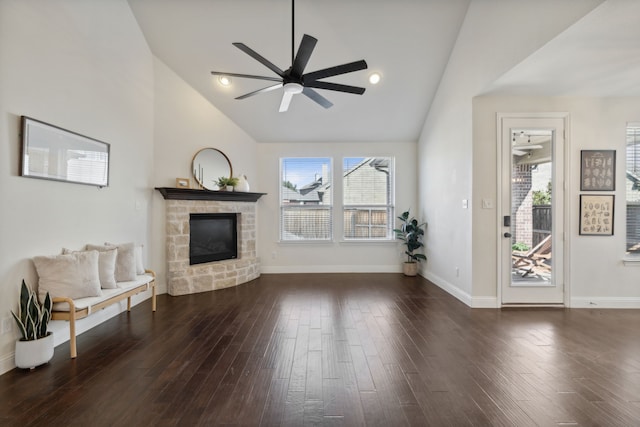 living room with ceiling fan, a fireplace, high vaulted ceiling, and dark wood-type flooring