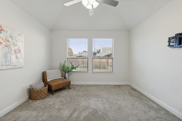 living area featuring ceiling fan, light colored carpet, and vaulted ceiling