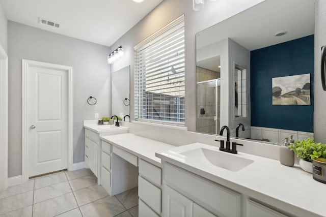 bathroom featuring vanity, tile patterned floors, and a shower with shower door