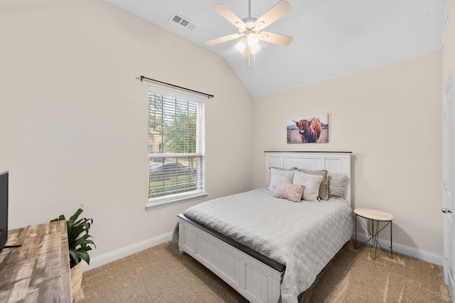 carpeted bedroom with ceiling fan and vaulted ceiling