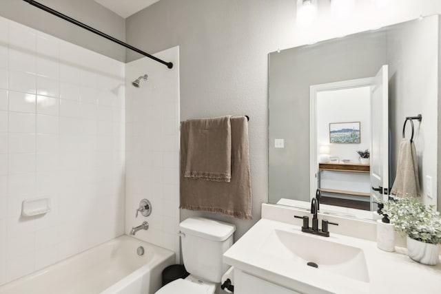 full bathroom featuring toilet, vanity, and tiled shower / bath