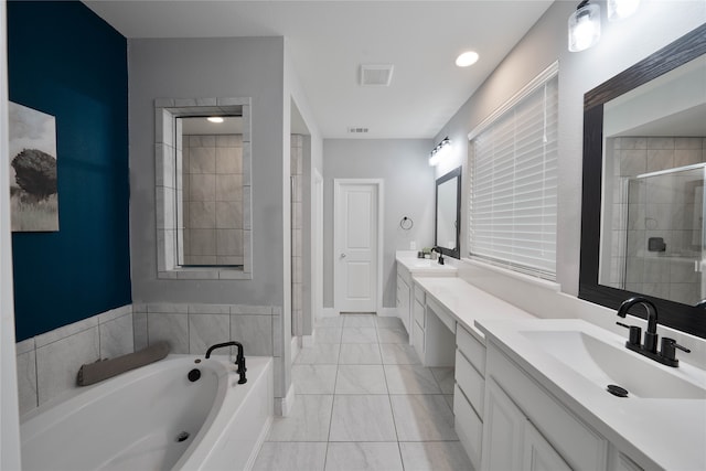 bathroom featuring double vanity, visible vents, a sink, a shower stall, and a bath