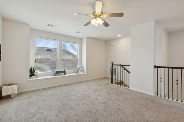 carpeted empty room featuring ceiling fan