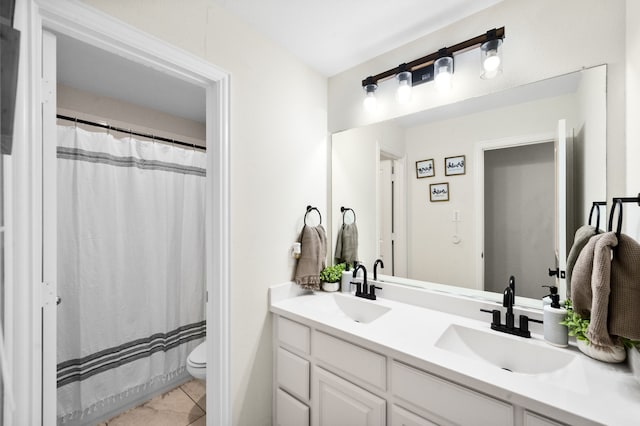 bathroom featuring tile patterned flooring, vanity, and toilet