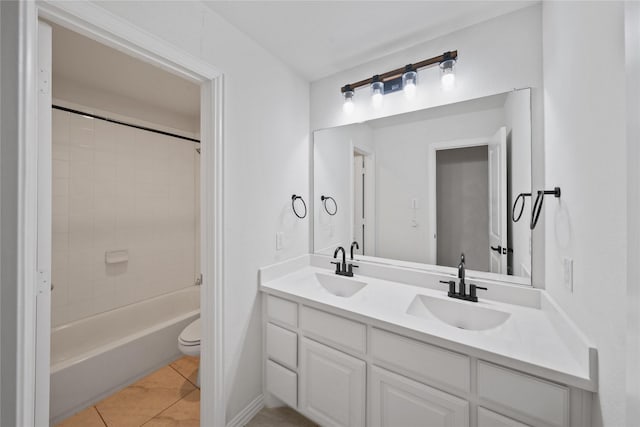 bathroom featuring tile patterned flooring, a sink, shower / bathing tub combination, and double vanity