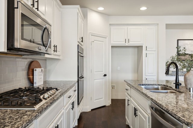 kitchen featuring white cabinetry, sink, stainless steel appliances, and stone countertops