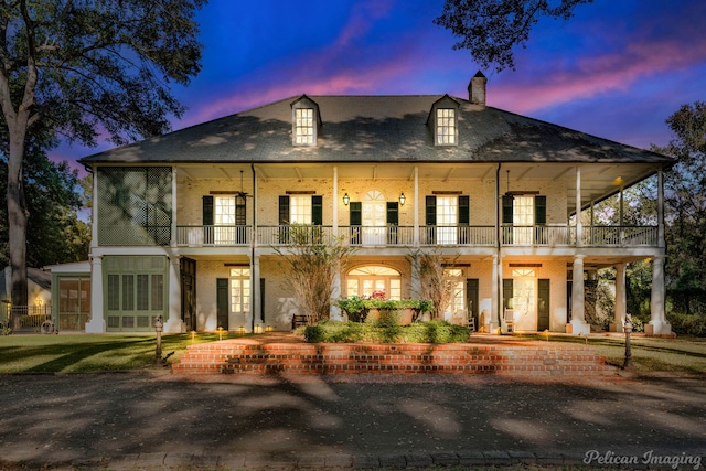 view of front of property with a porch and a balcony