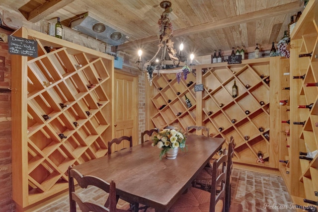 wine cellar featuring a chandelier, beam ceiling, and wood ceiling