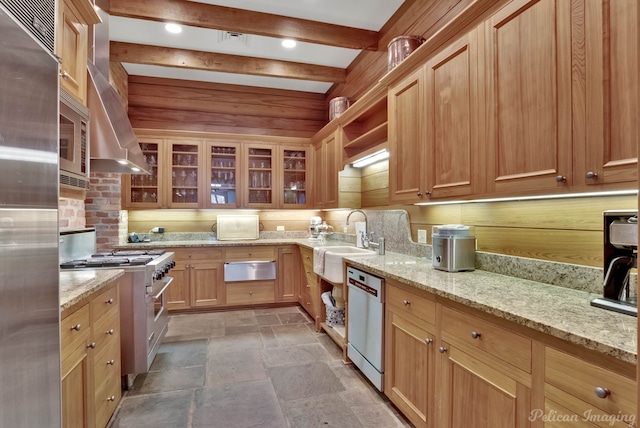 kitchen with light stone countertops, sink, beamed ceiling, and premium appliances