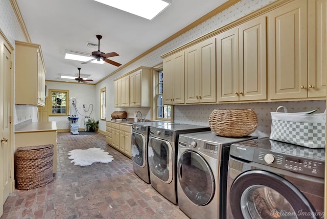 clothes washing area with ceiling fan, sink, cabinets, separate washer and dryer, and ornamental molding