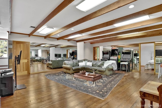 living room featuring beam ceiling and hardwood / wood-style floors