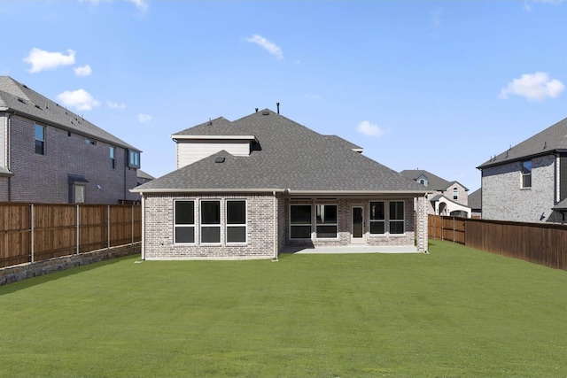 rear view of house with a patio and a yard