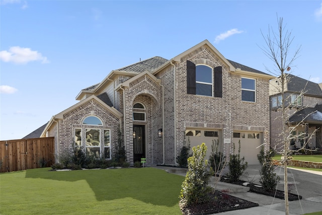 view of front of home with a front lawn and a garage