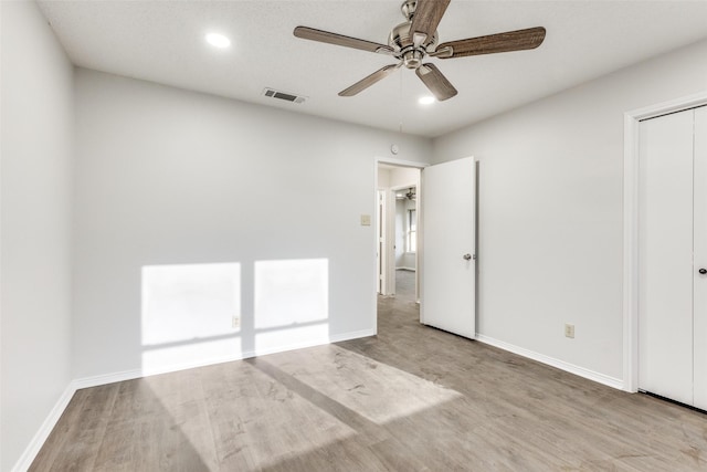 unfurnished bedroom featuring light hardwood / wood-style floors and ceiling fan