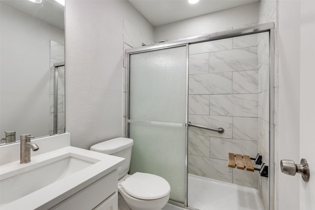 bathroom featuring vanity, toilet, and walk in shower