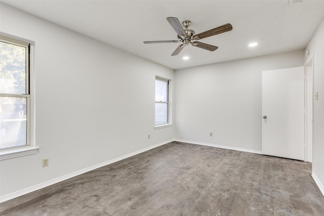 unfurnished room featuring hardwood / wood-style flooring, ceiling fan, and a healthy amount of sunlight