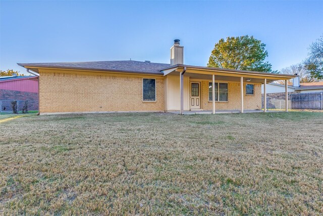 back of house featuring a yard and a patio