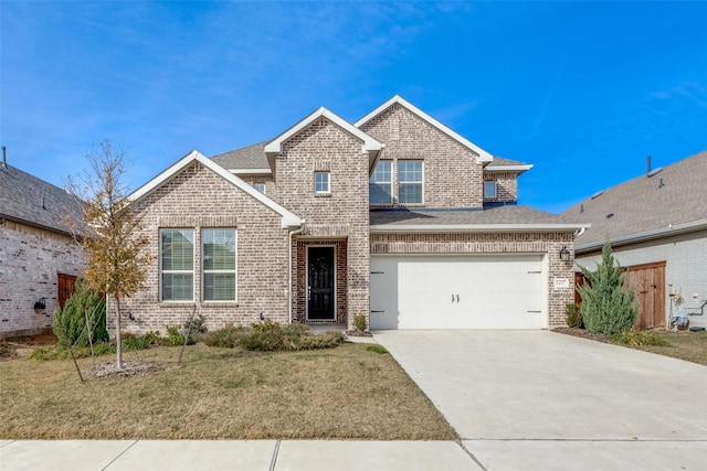 view of front of home featuring a garage and a front lawn