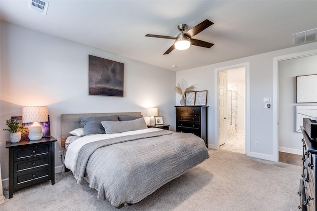 carpeted bedroom featuring ensuite bathroom and ceiling fan