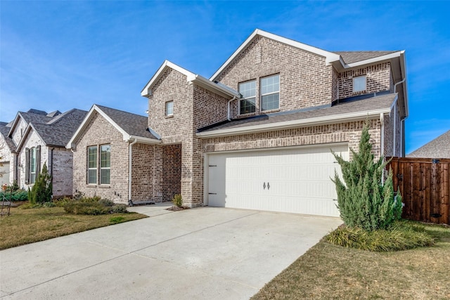 view of property with a front lawn and a garage