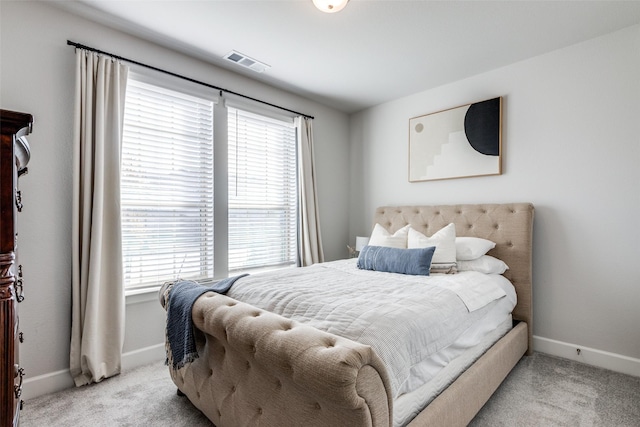 bedroom featuring light carpet