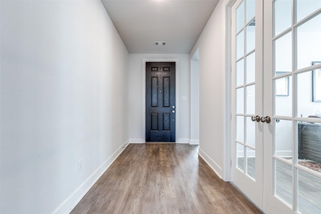 doorway to outside with french doors and light wood-type flooring