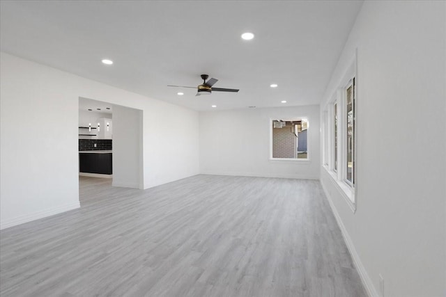 spare room featuring light hardwood / wood-style flooring and ceiling fan