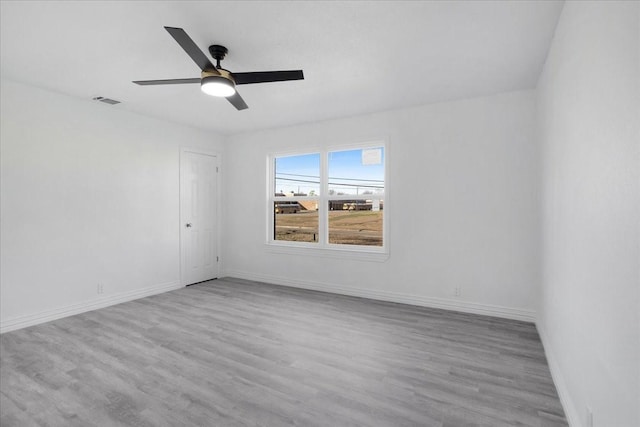 unfurnished room with ceiling fan and light wood-type flooring