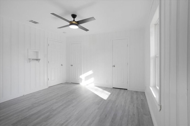 spare room with light hardwood / wood-style flooring and ceiling fan