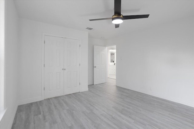 unfurnished bedroom with ceiling fan, a closet, and light hardwood / wood-style floors