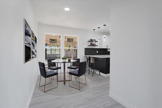 dining space with light hardwood / wood-style flooring