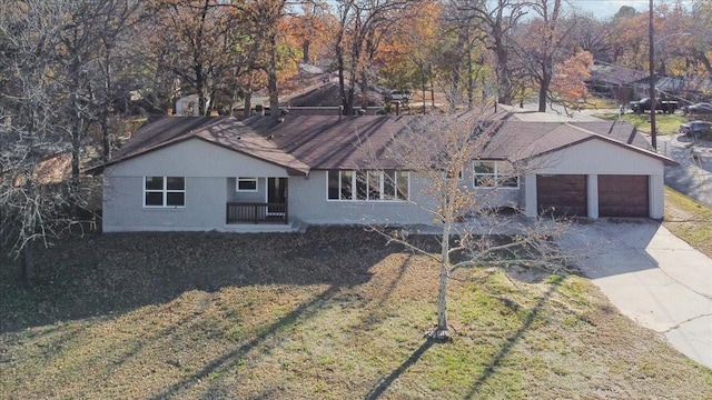 ranch-style house featuring a front yard and a garage