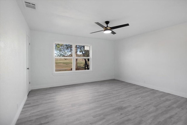 empty room with light wood-type flooring and ceiling fan