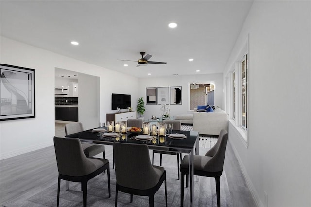 dining space with hardwood / wood-style floors and ceiling fan