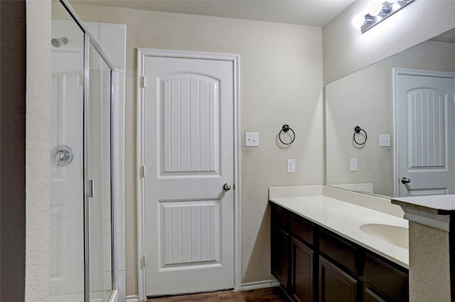 bathroom featuring vanity and a shower with shower door