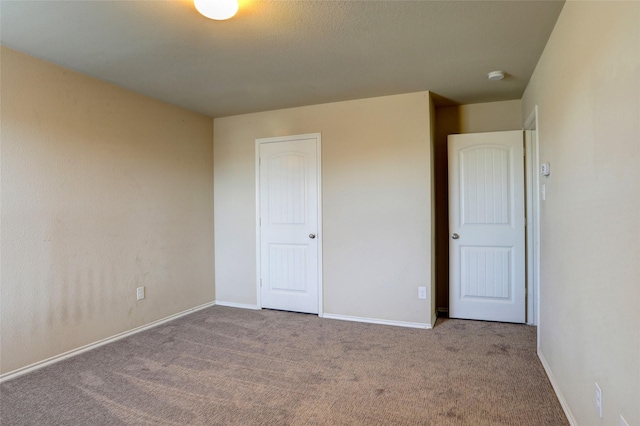 unfurnished bedroom with light carpet