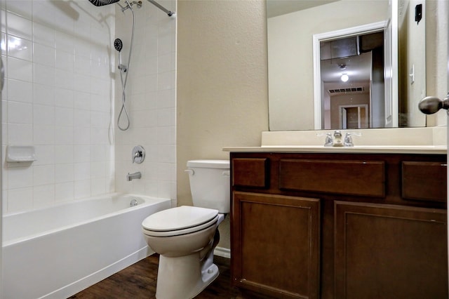 full bathroom with vanity, wood-type flooring, toilet, and tiled shower / bath