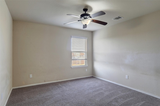 unfurnished room featuring ceiling fan and dark carpet