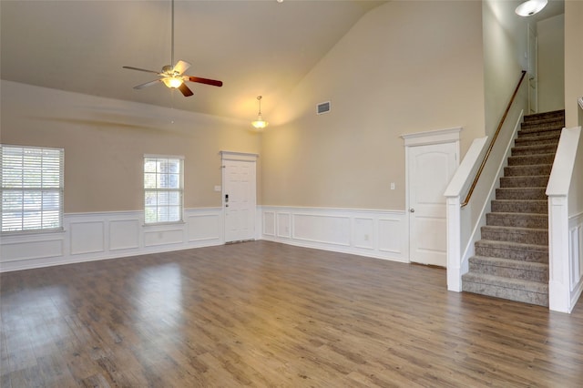 unfurnished living room featuring wood-type flooring, high vaulted ceiling, and ceiling fan