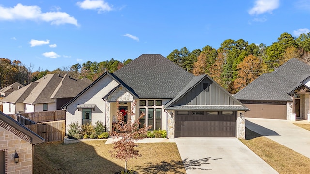 modern farmhouse style home featuring a front yard and a garage