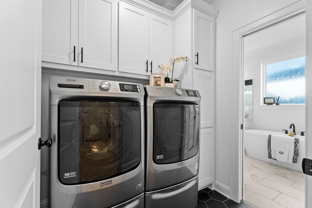 laundry room with cabinets and separate washer and dryer