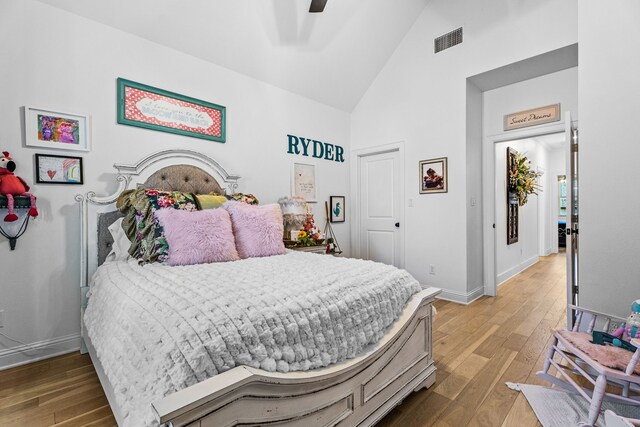 bedroom featuring hardwood / wood-style flooring, high vaulted ceiling, and ceiling fan