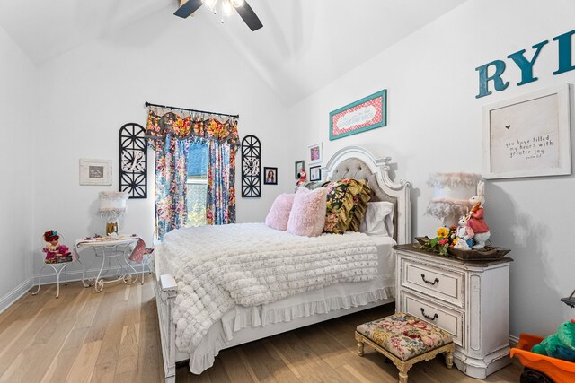 bedroom with ceiling fan, vaulted ceiling, and light wood-type flooring